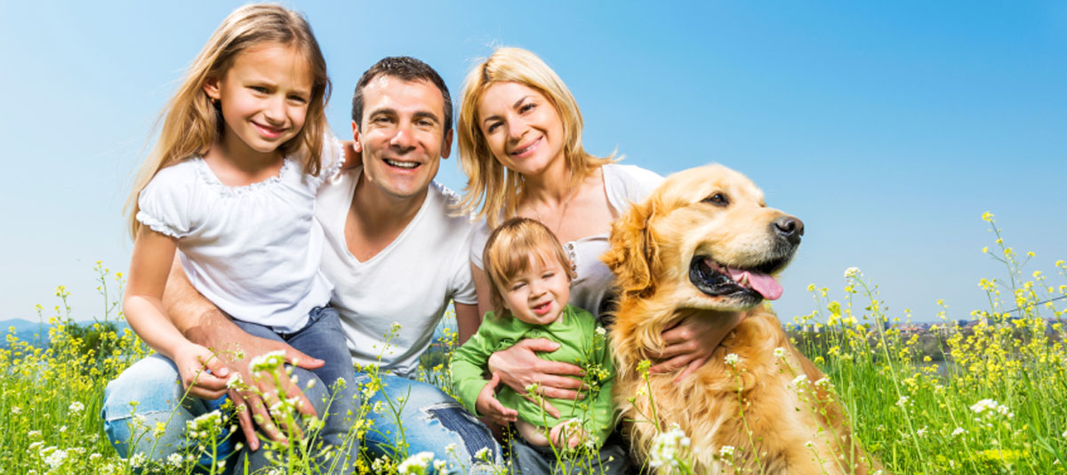 Happy family with a golden retriever.